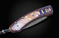 Folding knife with decorative handle on a black background