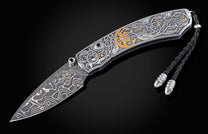 Decorative knife with intricate patterns on a dark background