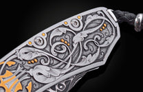 Decorative knife with intricate patterns on a dark background
