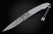 Decorative knife with damascus blade and meteorite handle on a black background shown open