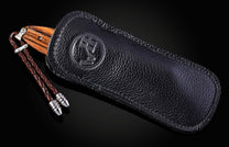 William Henry knife with zebra wood handle and damascus steel blade on a black background