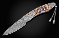 Damascus steel folding knife with amber-stained bone handle and engraved P51 Mustang details, side view on black background