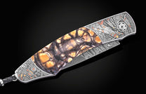 Luxury folding knife with amber-streaked mosaic handle and engraved P51 Mustang artwork, side view on black background