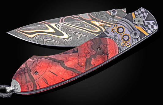 Damascus steel folding knife with a red textured handle and metallic frame engraved with automotive racing motifs.
