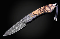 Hand engraved knife with Alaskan game animals, wooly mammoth tusk and damascus steel