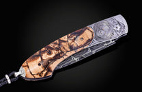 Hand engraved knife with Alaskan game animals, wooly mammoth tusk and damascus steel