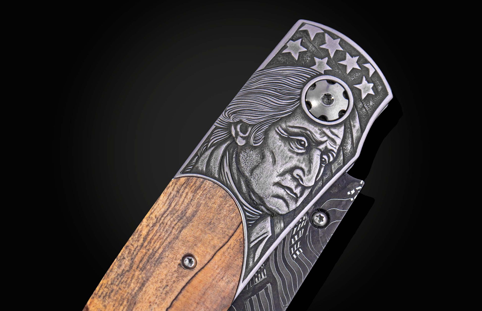 Folding knife with wooden handle and decorative blade on a black background