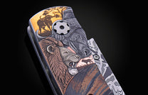 B12 Big 5 knife with an elaborately carved handle depicting a roaring lion, buffalo, tusked animal head, and leopard in multi-toned finishes.