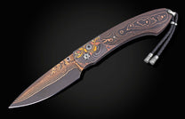 Folding knife with copper and carbon fiber handle on a black background shown fully open