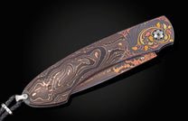 Folding knife with copper and carbon fiber handle on a black background shown closed