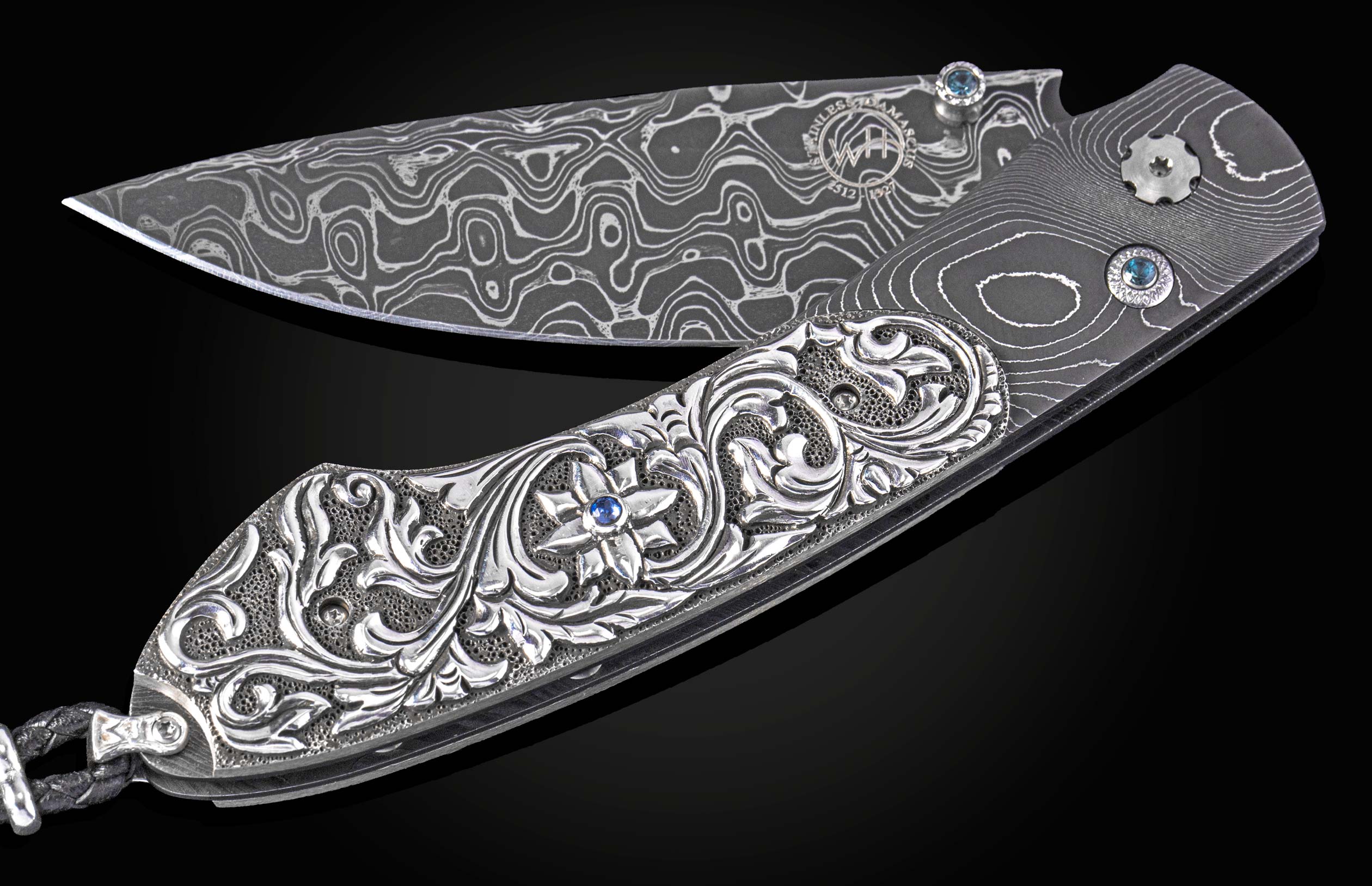 William Henry knife with hand carved sterling silver scales and damascus steel.