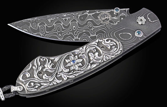William Henry knife with hand carved sterling silver scales and damascus steel.