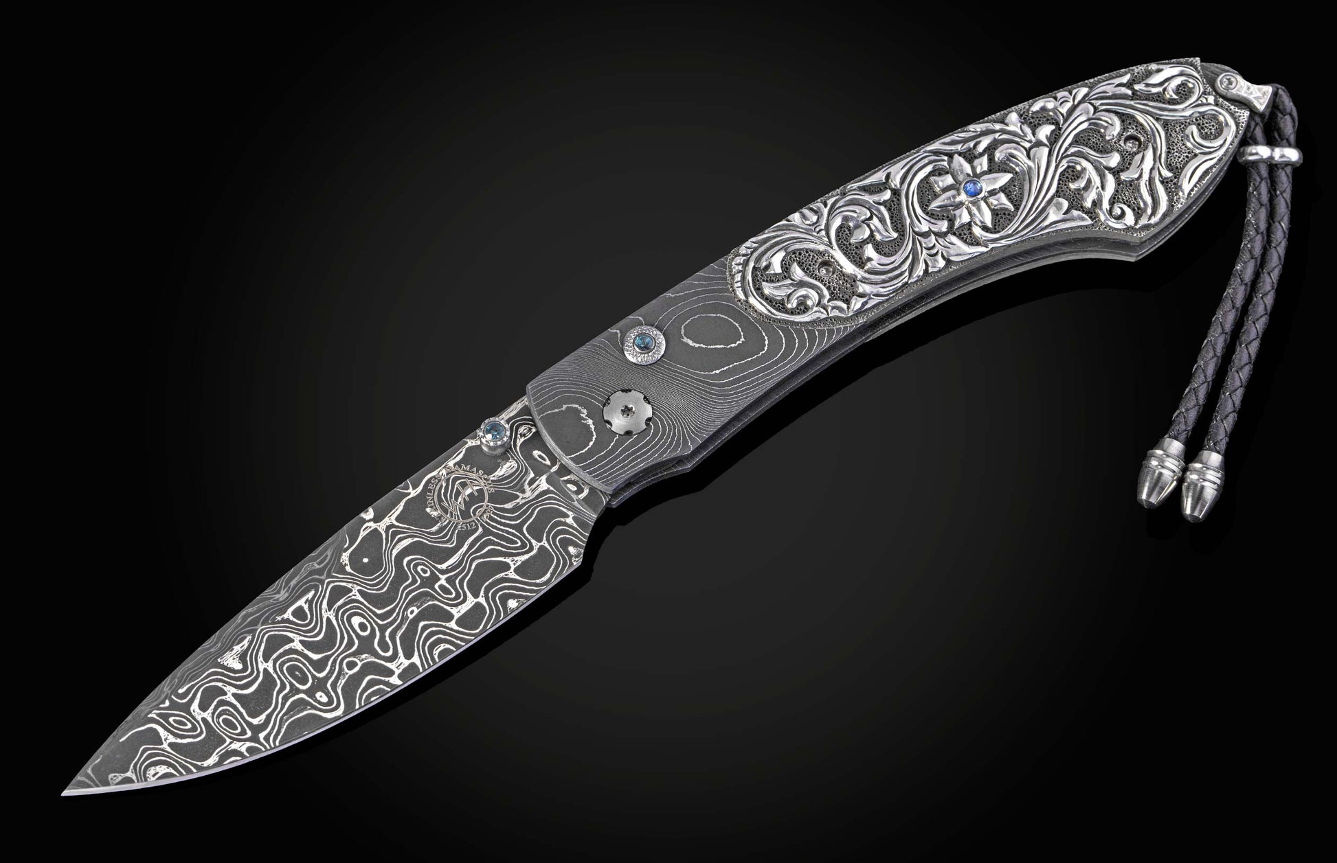 William Henry knife with hand carved sterling silver scales and damascus steel.