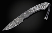William Henry knife with hand carved sterling silver scales and damascus steel.