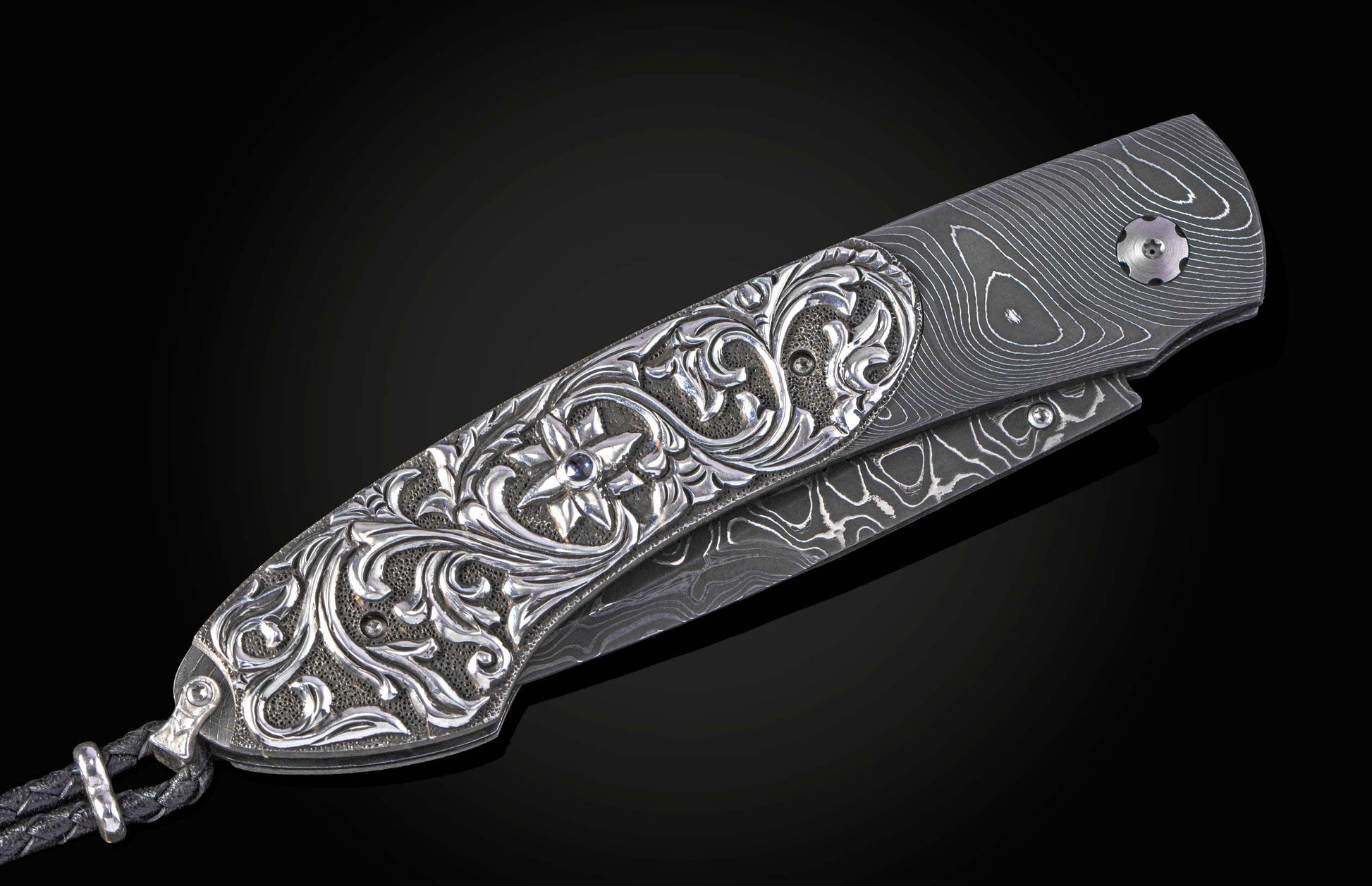 William Henry knife with hand carved sterling silver scales and damascus steel.