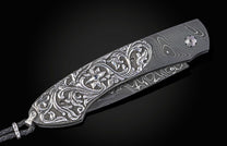 William Henry knife with hand carved sterling silver scales and damascus steel.