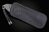 William Henry knife with hand carved sterling silver scales and damascus steel.