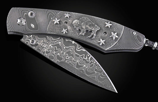 William Henry folding knife with damascus steel and hand carved sterling silver buffalo design