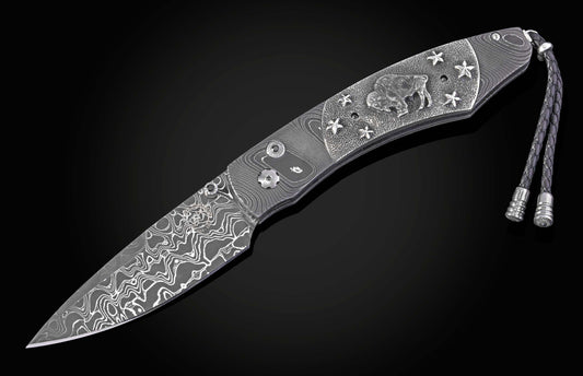 William Henry folding knife with damascus steel and hand carved sterling silver buffalo design
