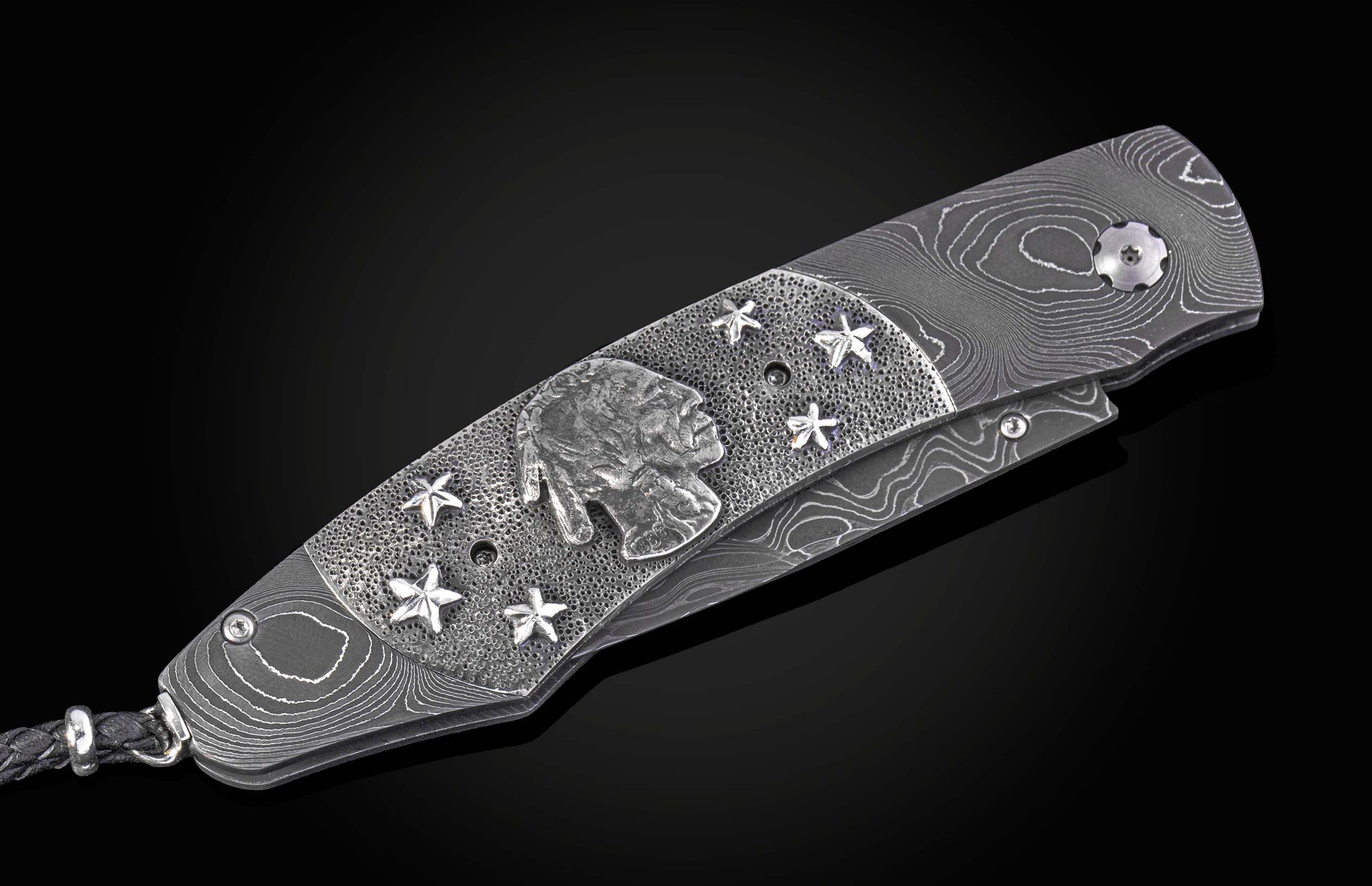 William Henry folding knife with damascus steel and hand carved sterling silver buffalo design