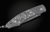William Henry folding knife with damascus steel and hand carved sterling silver buffalo design