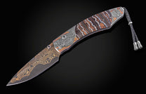 Decorative knife with intricate patterns on a dark background