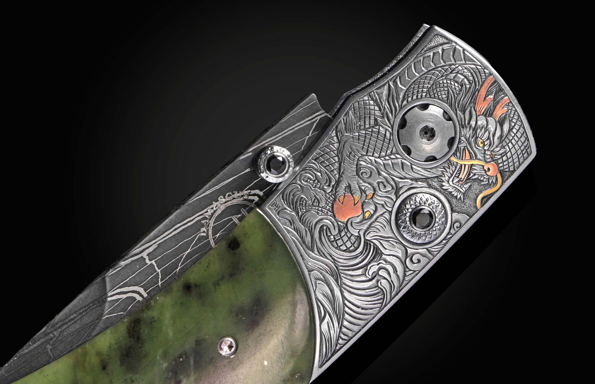 Luxury Damascus steel knife with intricately engraved Chinese dragon on silver handle, accented with orange details and black gemstones, side view on dark background