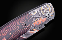 Knife with a dark handle featuring orange wavy lines and a silver body engraved with gears and an orange classic Camaro.