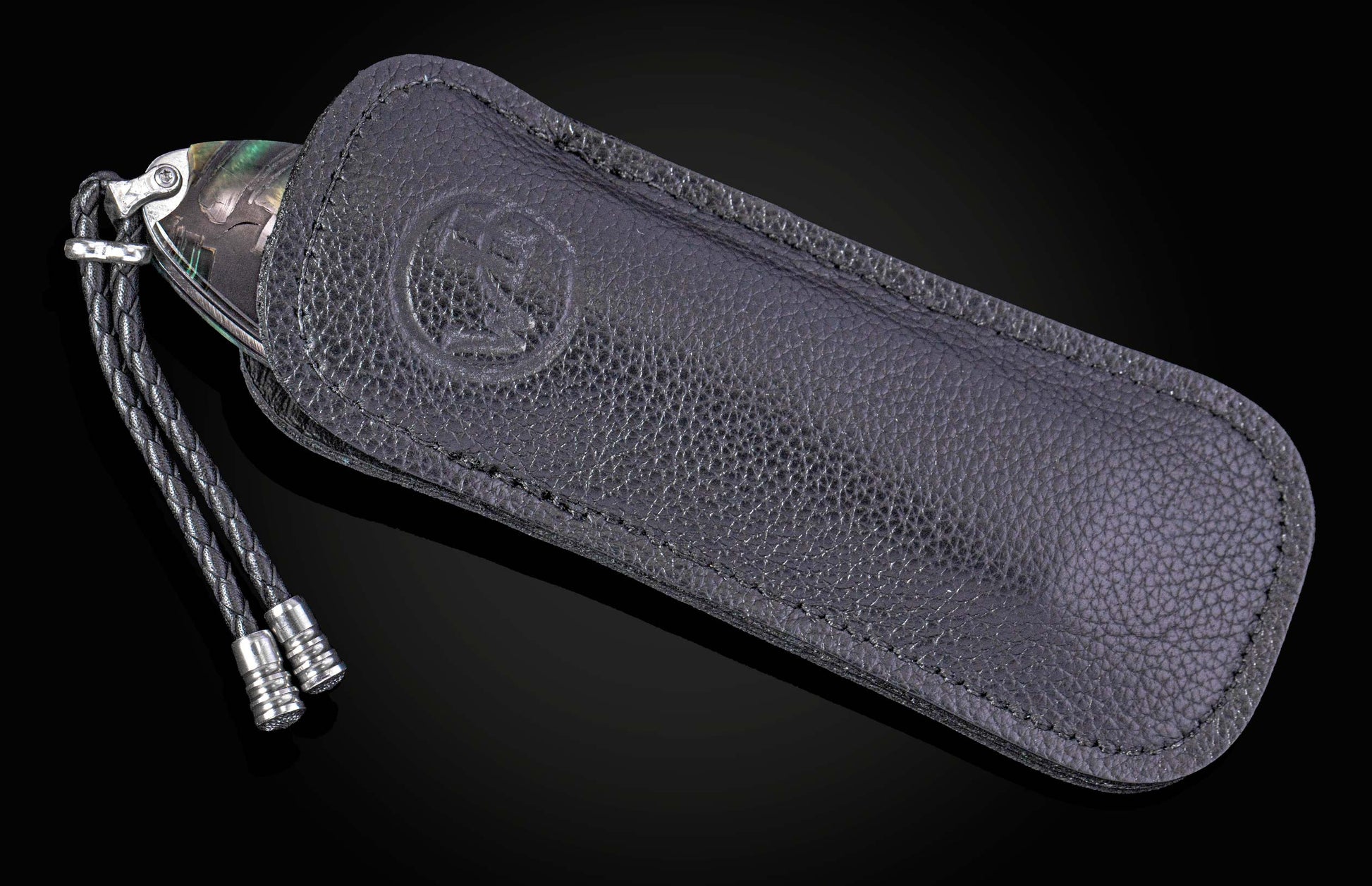 Hand engraved William Henry knife with mammoth tusk handle and damascus blade on a dark background