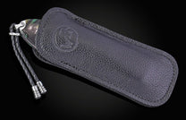 Hand engraved William Henry knife with mammoth tusk handle and damascus blade on a dark background