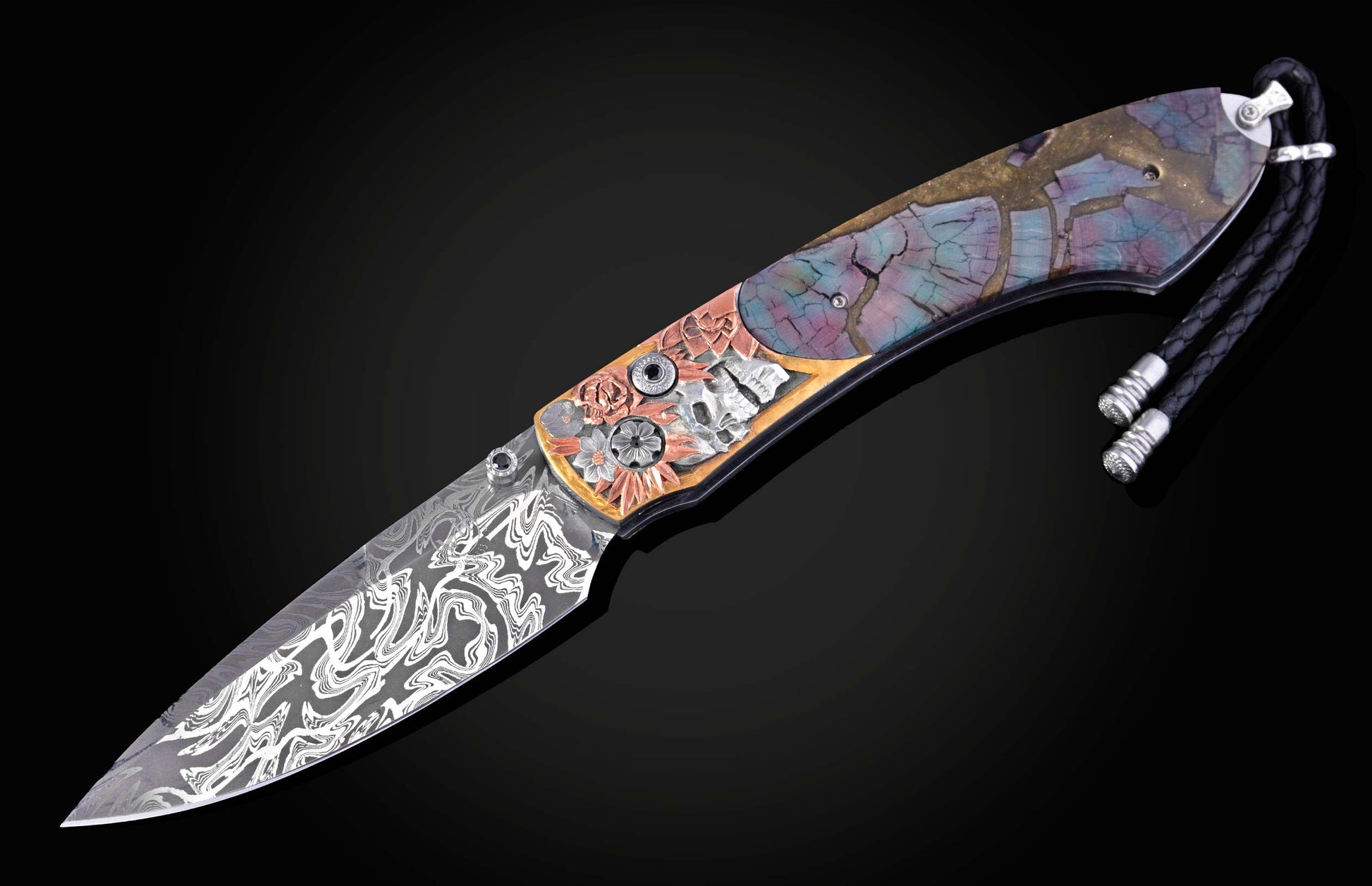 Ornate folding knife with wavy Damascus blade, carved copper floral and silver skull handle, colorful cracked mosaic inlay.