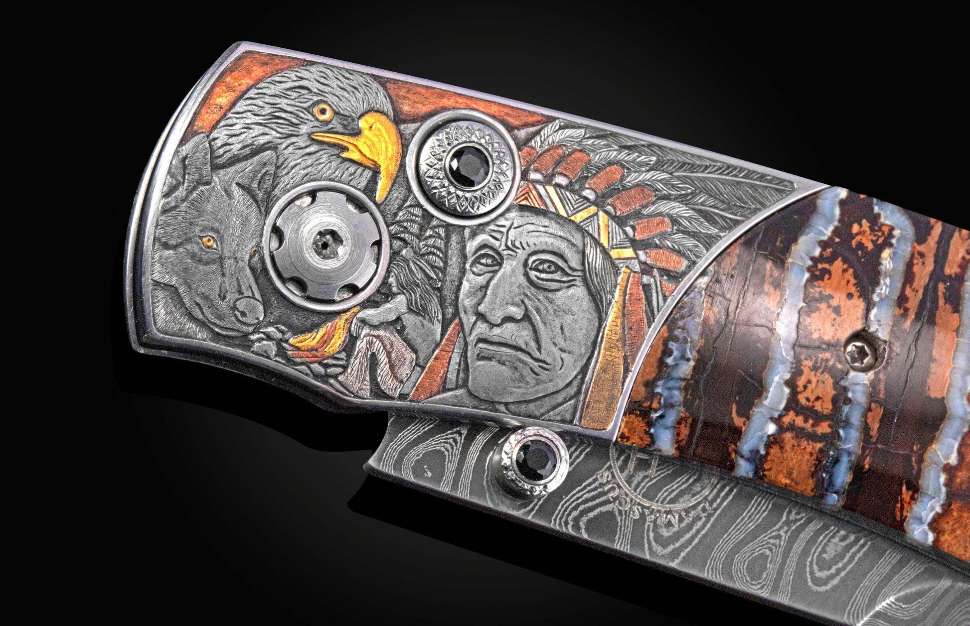 Close up image of hand carved images on a pocket knife showing native Americans, and eagle, and a wolf