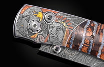 Close up image of hand carved images on a pocket knife showing native Americans, and eagle, and a wolf
