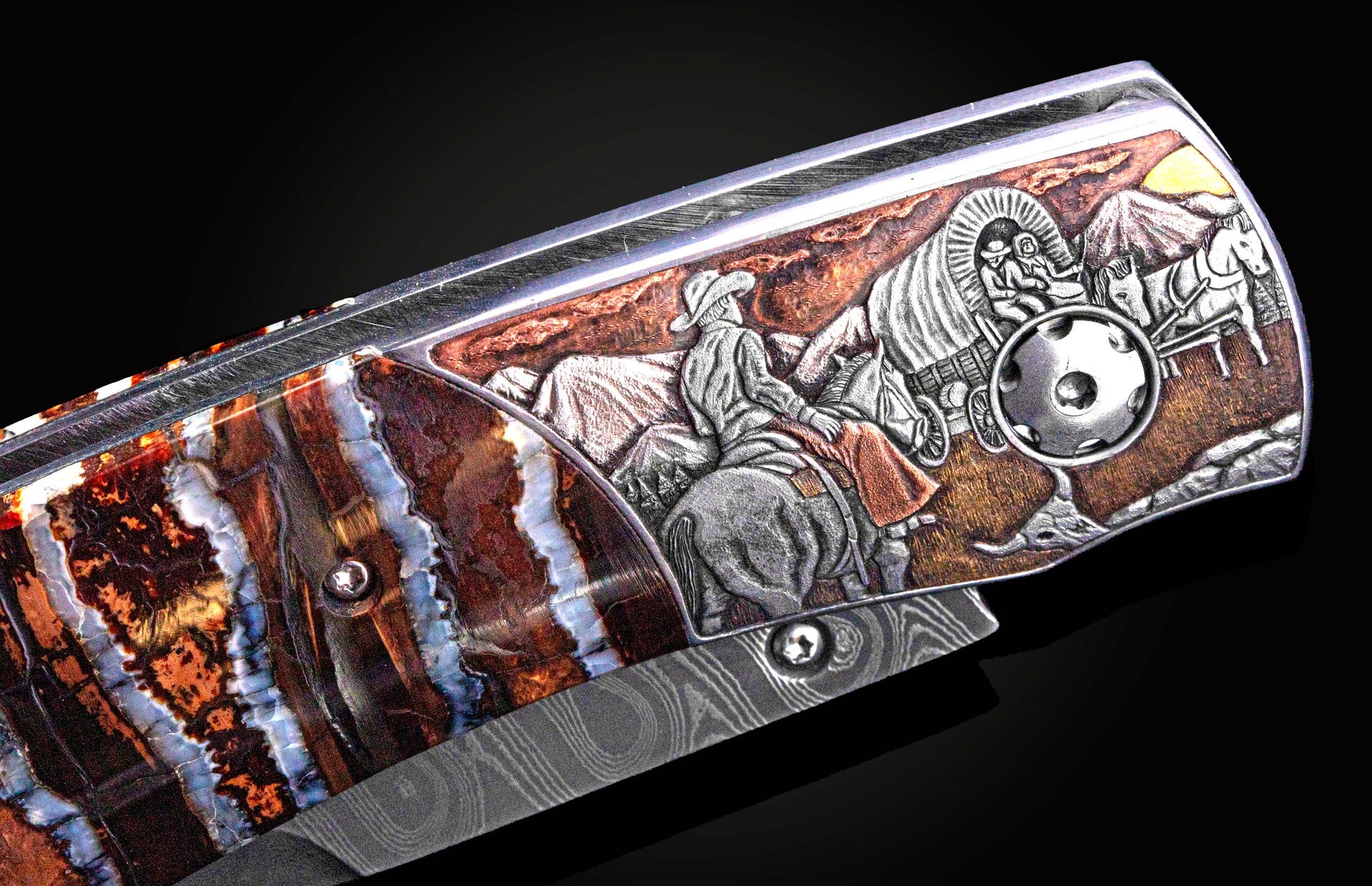 detail image of hand carving on a pocket knife depicting a cowboy on horseback and a covered wagon