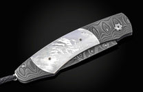 Luxury folding knife with mother-of-pearl inlay and damascus steel handle, by B12, side view on black background