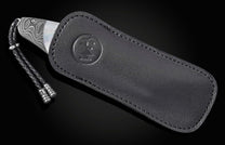 Luxury Damascus steel knife with mother-of-pearl inlay, by B12, in black leather sheath with braided cord and embossed logo, side view