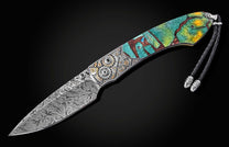Damascus steel knife with vibrant turquoise and amber mosaic handle, intricate gear detailing, and braided lanyard, side view on black background