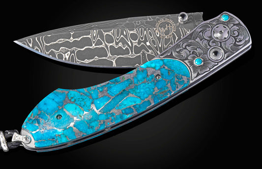 Hand engraved knife with turquoise and damascus blade partially open on a black background