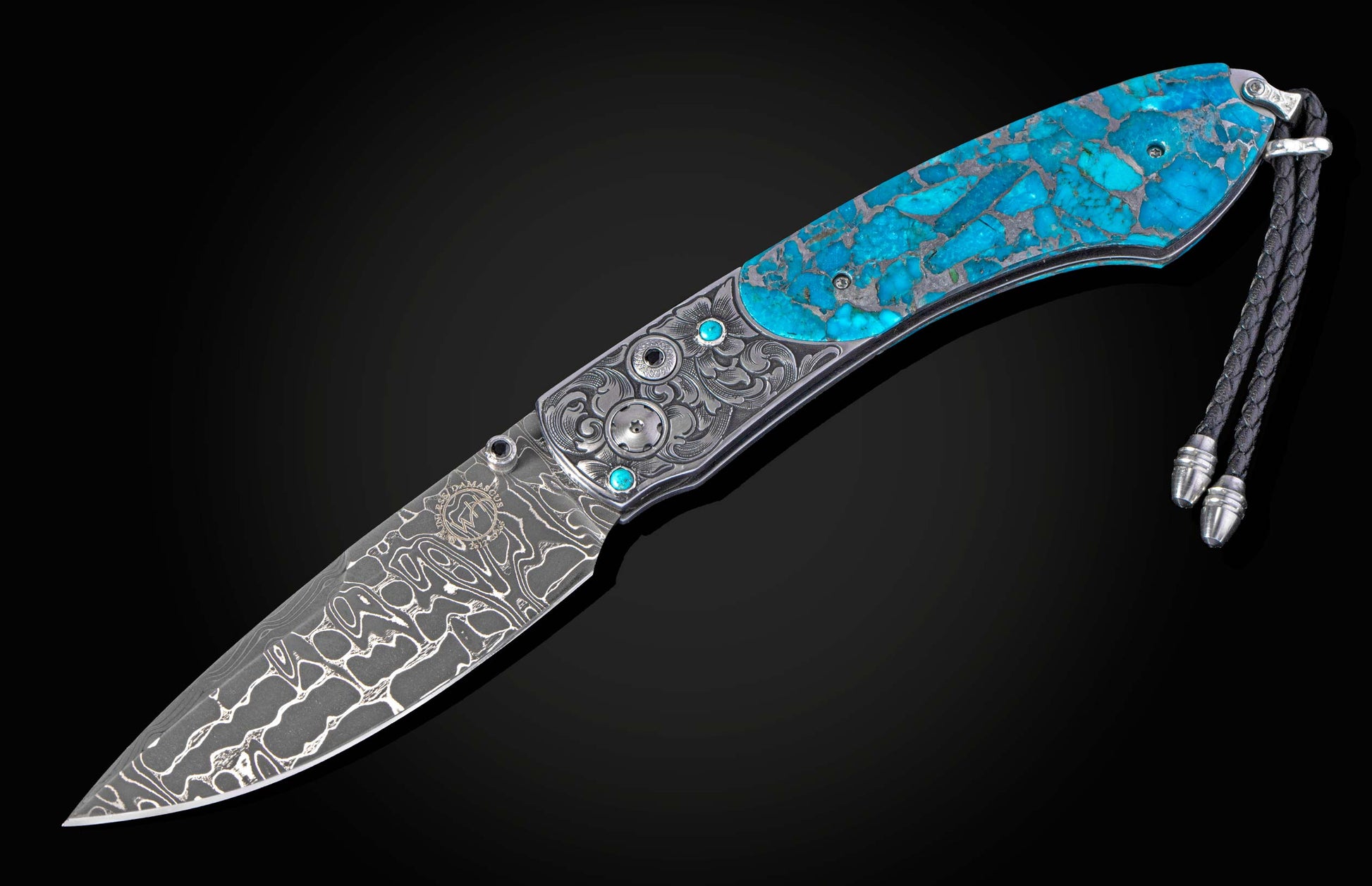 Hand engraved knife with turquoise and damascus blade fully open on a black background