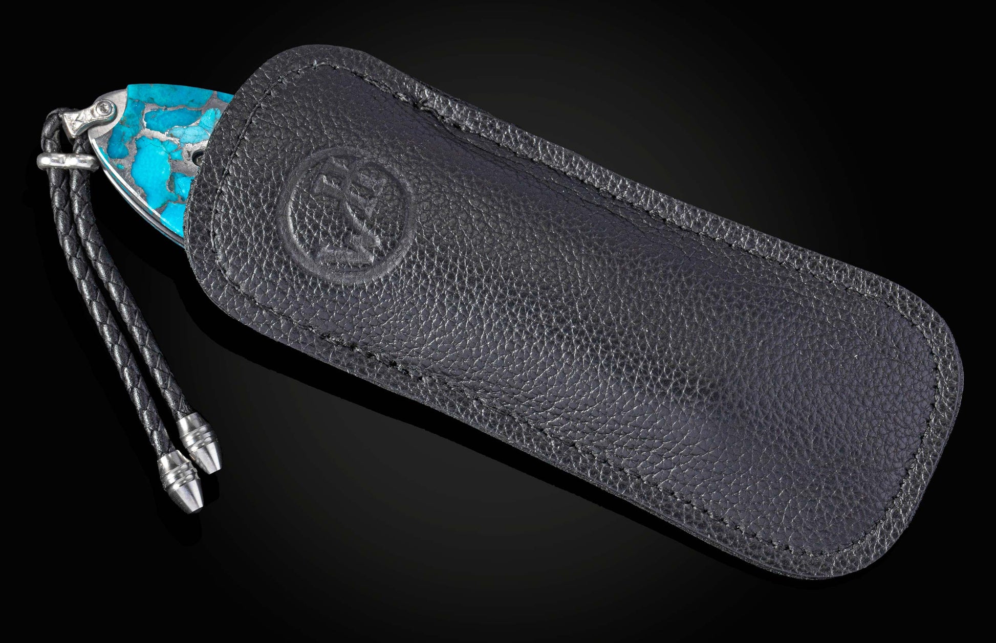 knife with turquoise handle in black leather case 
