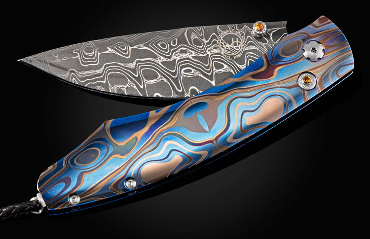 Folding knife with a Damascus steel blade and colorful handle on a black background