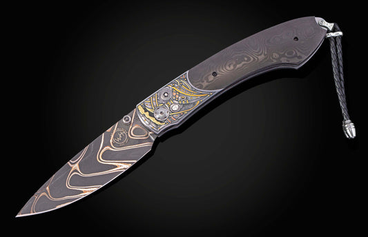 Decorative folding knife with intricate patterns on a black background