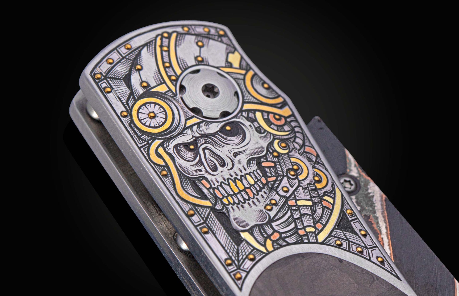 close up view of knife with intricate hand engraved skull with gold inlays