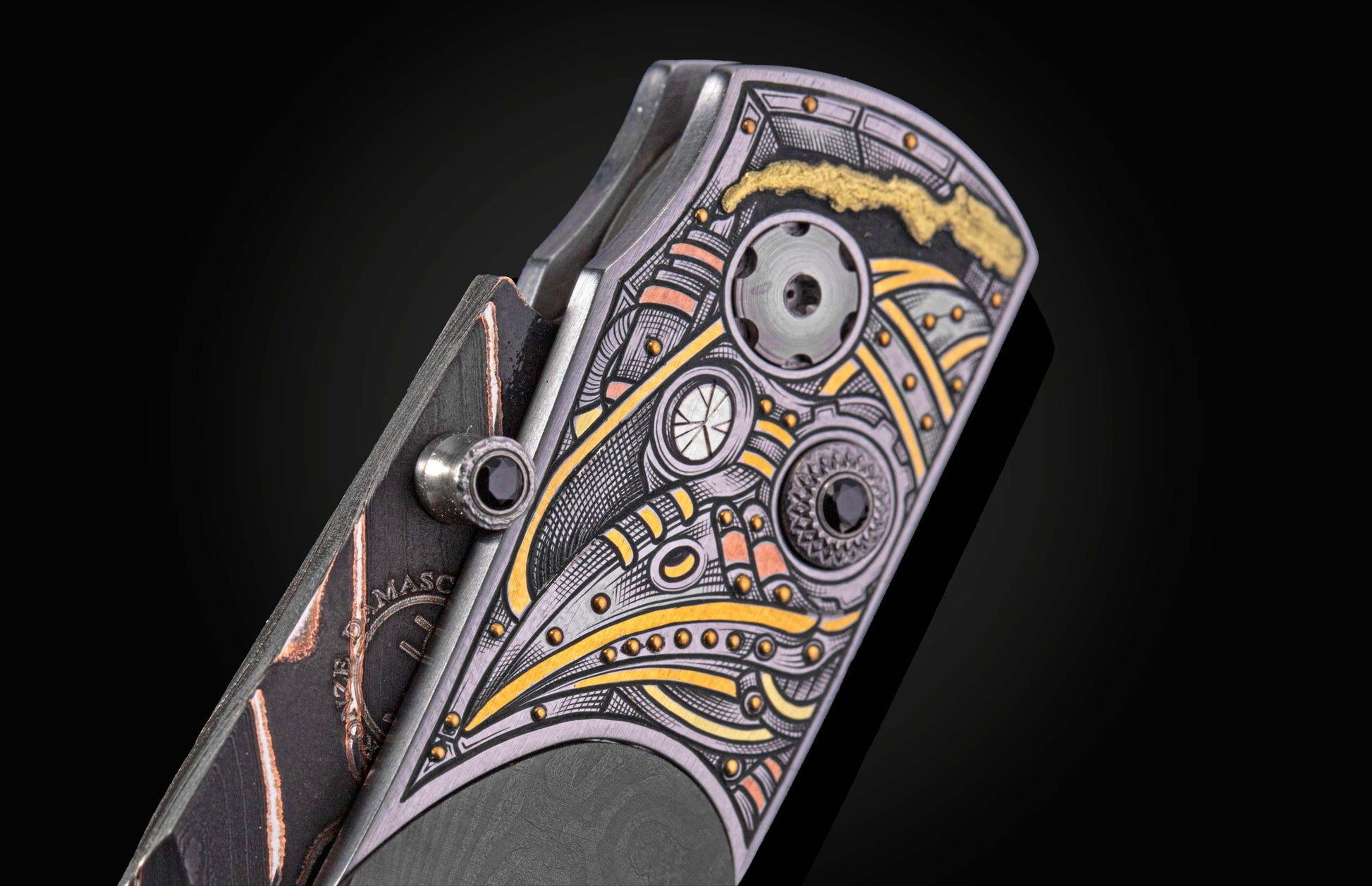 close up view of knife with intricate hand engraved mask with gold inlays