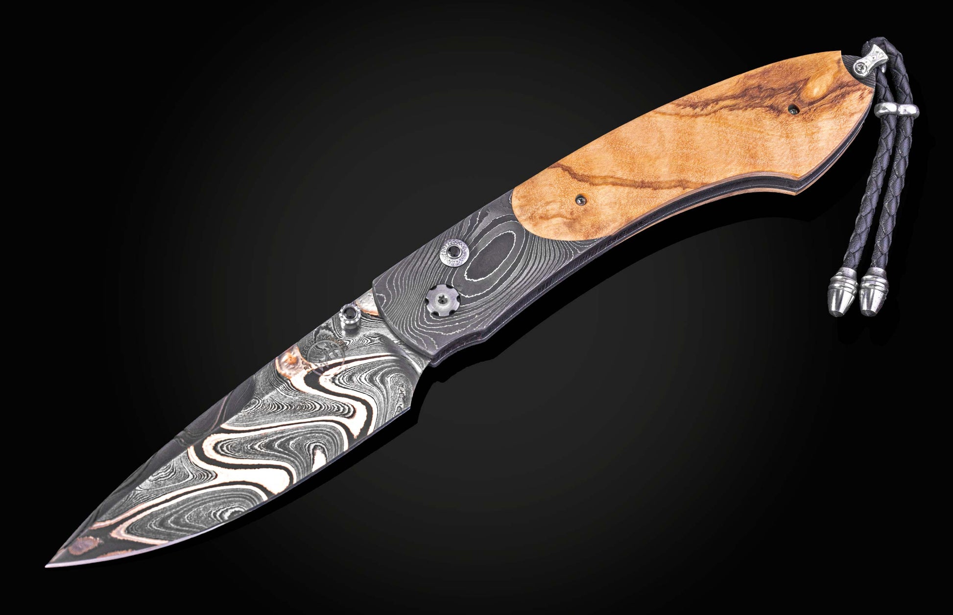 Decorative knife with wooden handle and metal blade on a dark background