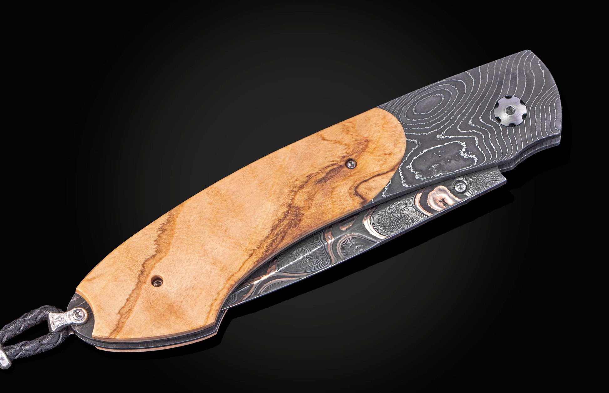 Folding knife with wooden handle on a black background