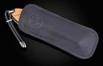 Black leather case with knife on a black background