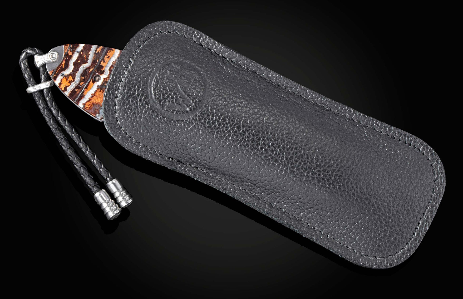 fossil mammoth tooth handle on knife sticking out of black leather case