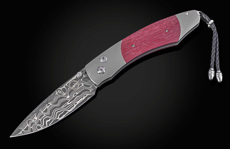 Folding knife with a purple heart wood handle and damascus blade on a black background