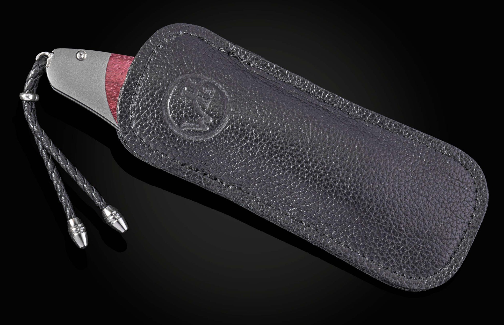 Folding knife with a purple heart wood handle and damascus blade on a black background